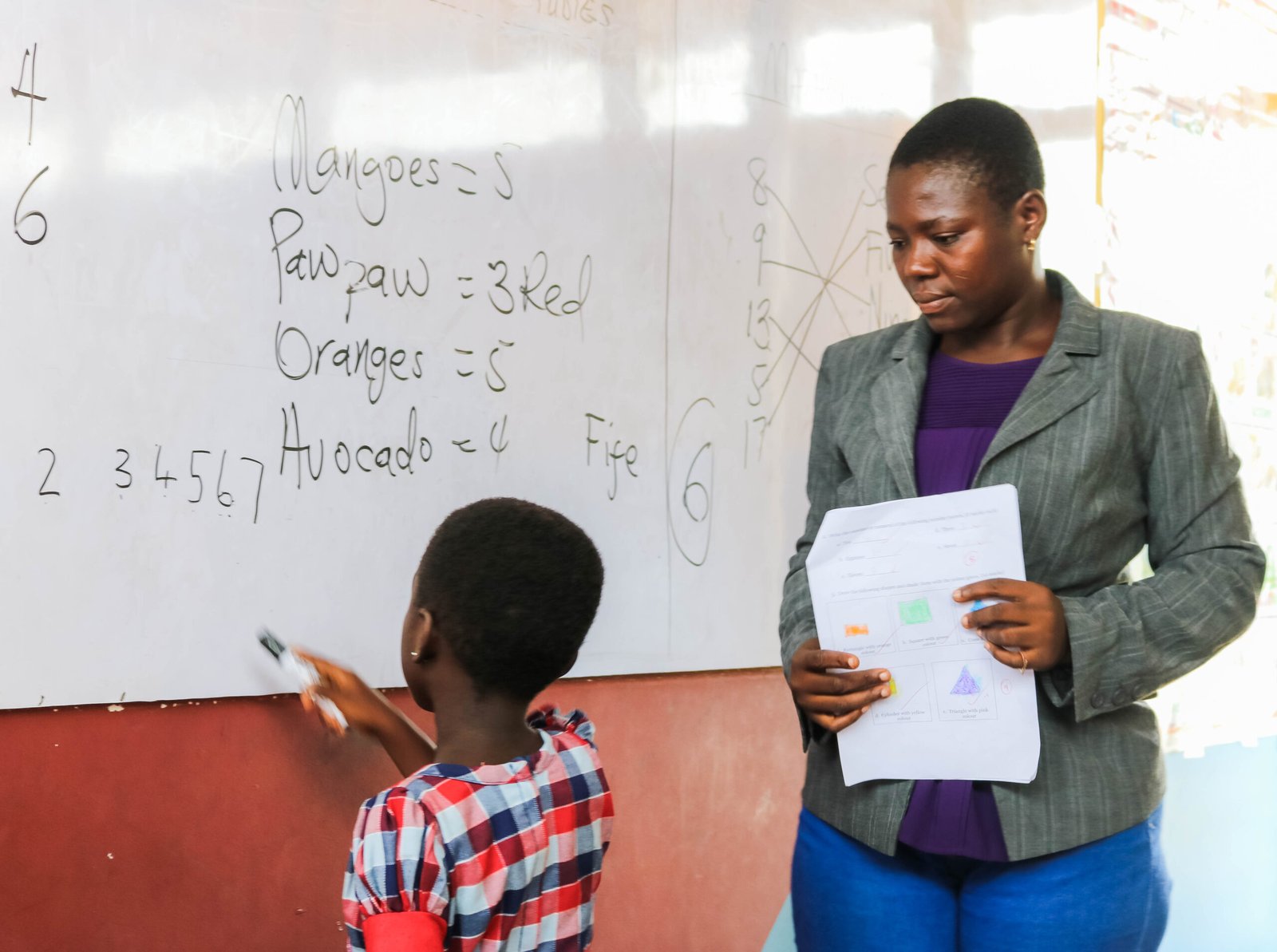 A teacher guides a student through the BrainStay platform